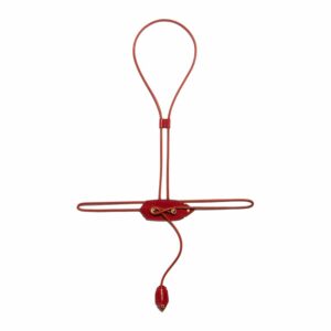 Red Nozzle Harness in waxed acrylic and vegetable leather with feather in the center of the chest, adjustable lace ending with a feather with gold details by Domestique at Brigade Mondaine