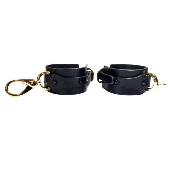 Black leather handcuffs with details and gold ELF ZHOU strap at Brigade Mondaine