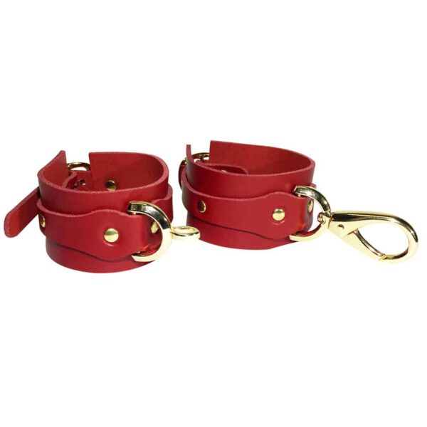 Red leather handcuffs with details and gold ELF ZHOU strap at Brigade Mondaine