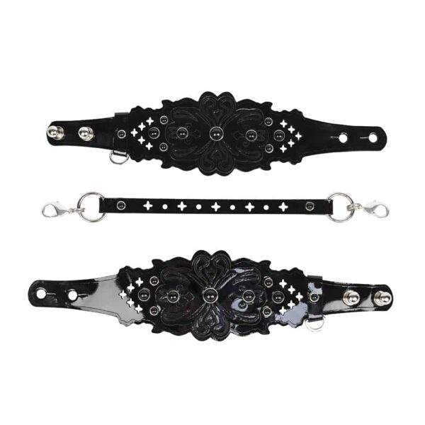 Black patent leather handcuffs with beaded pattern and perforated leather carabiner link with round and crosses by FRAULEIN KINK at Brigade Mondaine