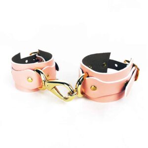 Pink leather handcuffs with gold ELF ZHOU strap at Brigade Mondaine