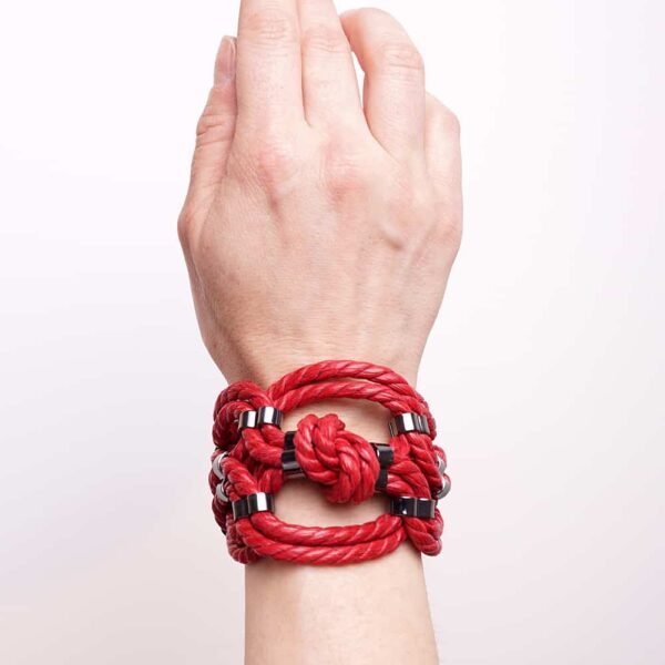 Red shibari bondage knotted rope bracelet with nickel-free metal detail Figure of A at Brigade Mondaine