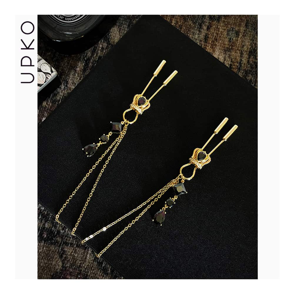 Crown nipple clamps in gold and black crystals with chain and UPKO pendants at Brigade Mondaine