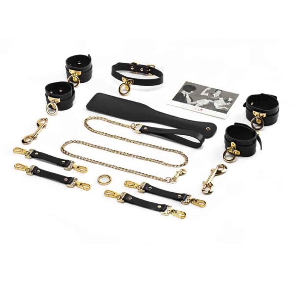 Black leather bondage accessories, handcuffs and tie with 24K gold details, leash and chocker, spanking paddle UPKO at Brigade Mondaine