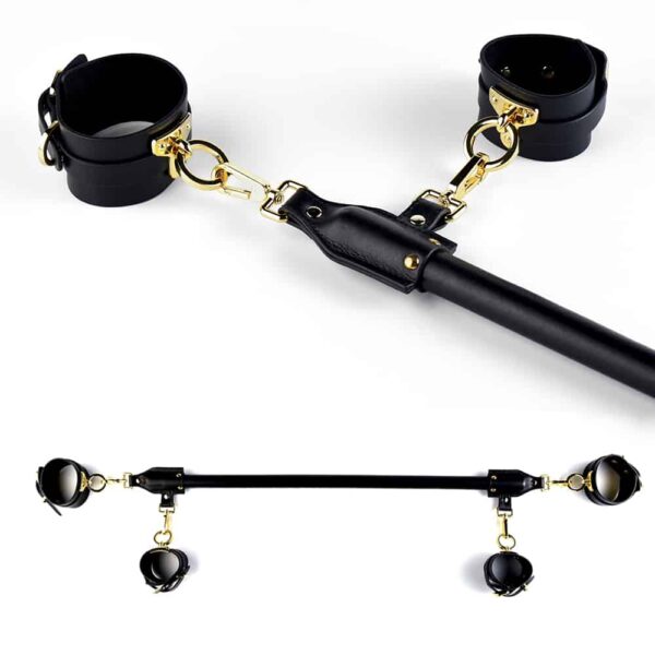 Black leather spreader bar with gold finish, attachable to UPKO wrists and ankles at Brigade Mondaine