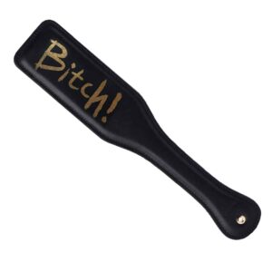 Spanking paddle in black leather and gold finish with gold inscription UPKO at Brigade Mondaine