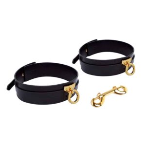 Handcuffs for thighs in black leather and 24K gold attachments handmade by UPKO at Brigade Mondaine
