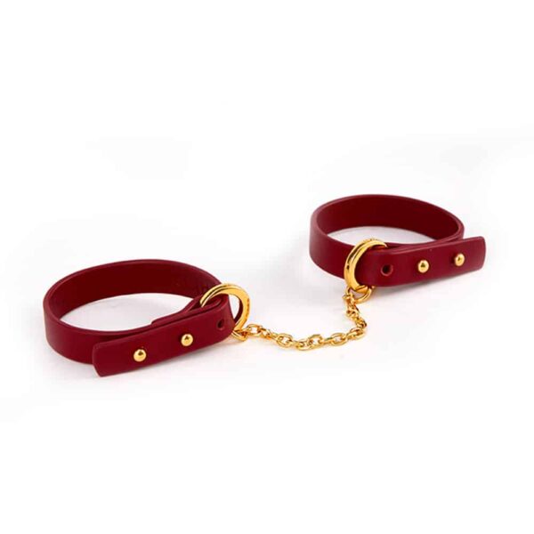 Thin red leather bracelet with 24K gold handcuffs UPKO at Brigade Mondaine