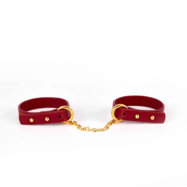 Thin red leather bracelet with 24K gold handcuffs UPKO at Brigade Mondaine