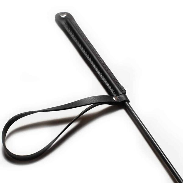 Black leather whip with a strap on the flattened handle and Baed Stories logo on the tip
