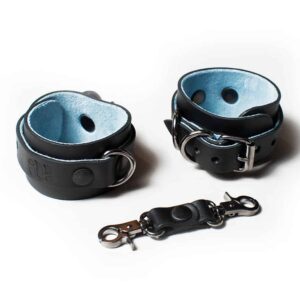 Black leather handcuffs with silver fasteners and details and soft blue interior.