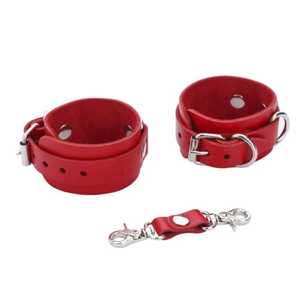 Thin red leather handcuffs with silver detailing and fasteners