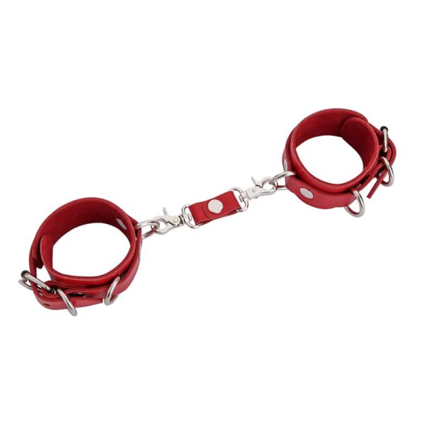 Thin red leather handcuffs with silver detailing and fasteners