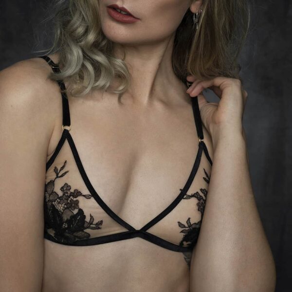 Triangle bra by HERVÉ by Céline Marie, shaped with black velvet elastics and a transparent fabric decorated with black lace. The rings of the bra are golden.