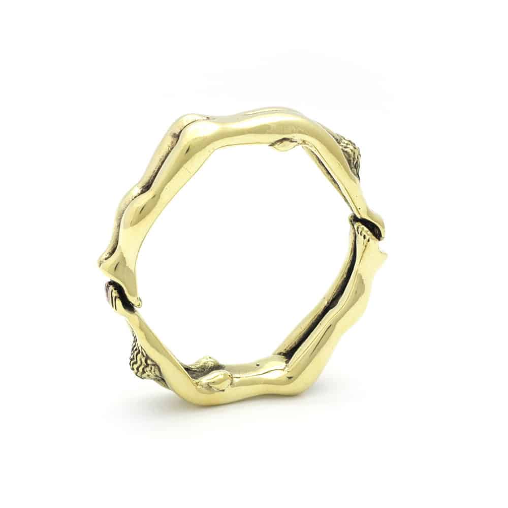 Ballring Rosebuds, elegante objeto de bronce dorado. La ronda de este anillo está hecha de cuerpos de mujeres que forman la ronda.