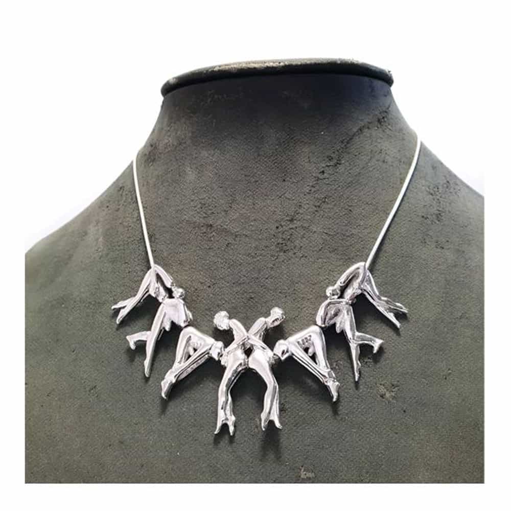 Silver Rosebuds necklace made of different people connected to each other. There are three people on each side and two people in the center.