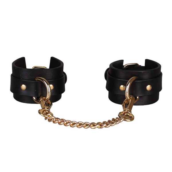 Leather handcuffs & chains from Elif Domanic. These handcuffs are embellished with an iron loop that allows you to connect the two handcuffs with a chain.