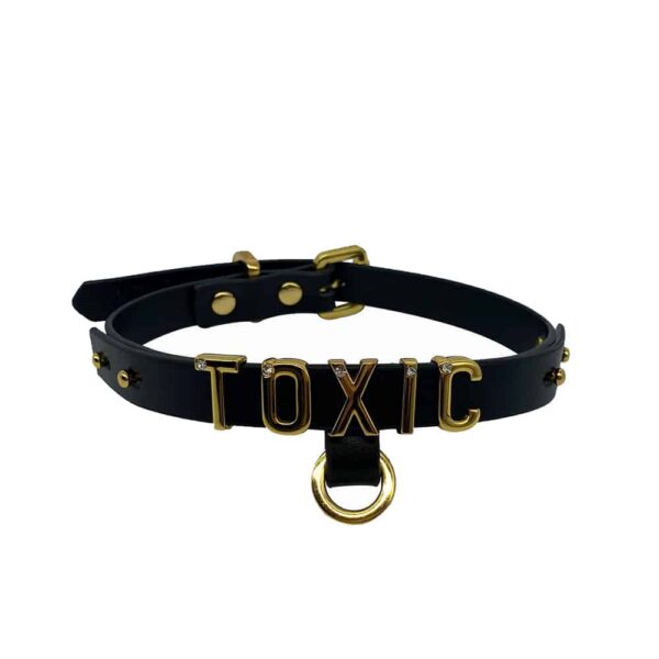 Necklace / choker in soft black Italian leather with 24 karat gold plated letters and a small stone encrusted on each letter writing the word TOXIC from the UPKO X Brigade Mondaine collection available at Brigade Mondaine