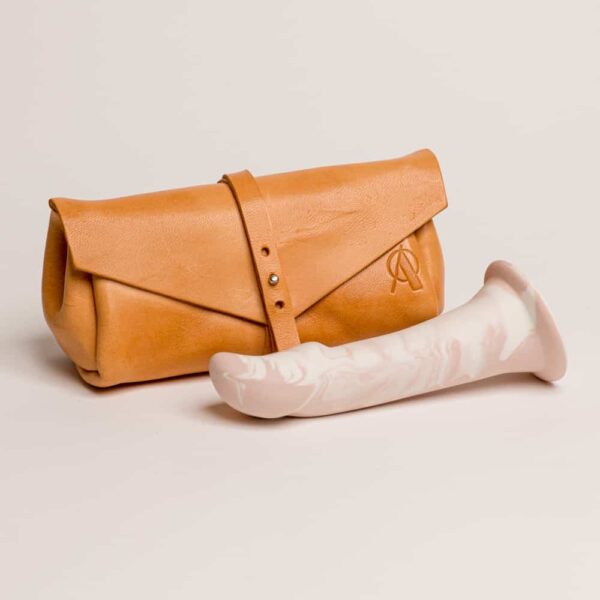 Orange leather clutch with brand logo on top. Flat shape on the long half oval toe Adeles brydges at brigade mondaine.