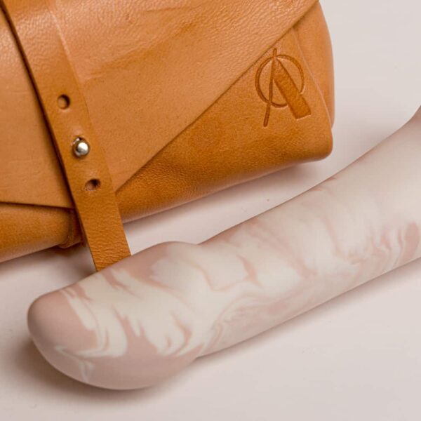 Orange leather pouch with the brand logo on it. Flat shape on the long half oval tip.