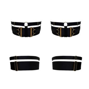 Garters from the Kora collection at Bordelle. These garters are black, a thick elastic wraps around the thigh and is embellished above a thinner elastic. The garters are adjustable and equipped with two jewels embossed with the Bordelle logo on each side of the garters. The two elastics are joined by a round loop and a thin elastic placed between the two jewels.
