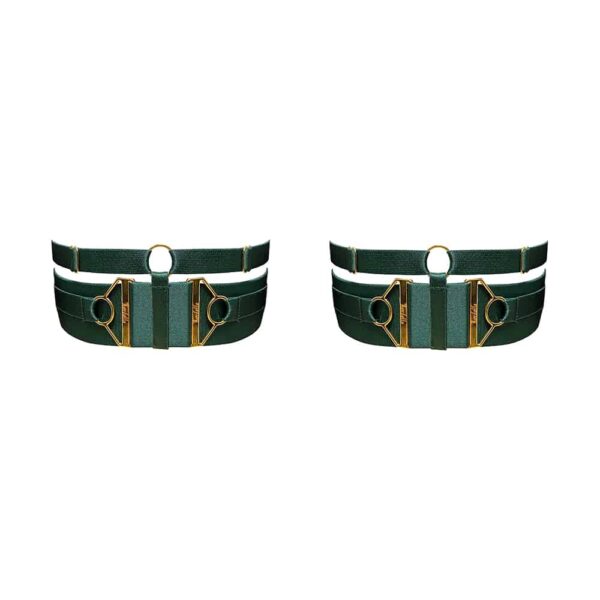 Garters from the Kora collection at Bordelle. These garters are green eden color, a thick elastic wraps the thigh and is embellished above a thinner elastic. The garters are adjustable and equipped with two jewels embossed with the Bordelle logo on each side of the garters. The two elastics are joined by a round loop and a thin elastic placed between the two jewels.