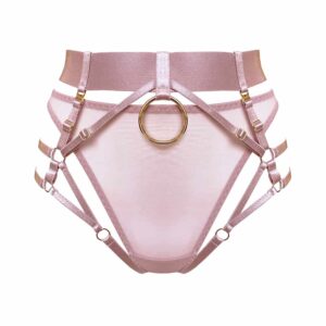Harness panties multi styles of the collection Kora at Bordelle. This panty is pink. A wide belt made of a large elastic and decorated with a central ring as a pendant wraps around the waist. To this is added multiple thin elastic, all adjustable that form the hips and the shape of the panties. A part in satin elasticated material can be removed, it allows to obtain the result of a harness panty open or not. At the back, the elastic makes this panty completely open with an elastic placed so that it forms a thong. This elastic is also removable with a small hook embossed with the brand name.