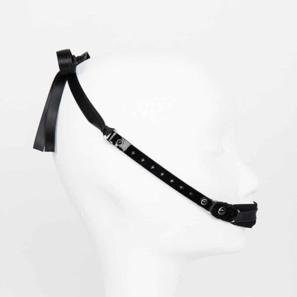 Entirely handmade and made to order in the brand's Berlin workshops, this Nero Fashion Gag is the perfect accessory to channel your ardor. Ultra comfortable and versatile, this gag is sure to bring out the naughty in you. Wear it as a hair accessory, a high waist belt or a necklace. Elegant black stretch tulle mouth gag Black pearl silver edged crystals Custom laser cut black leather straps Double sided satin ribbon closure with silver leaf logo Ultra comfortable and easy to wash.