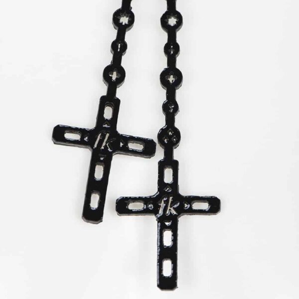 The black Nero Rosary Necklace is made entirely by hand and to order in the brand's Berlin workshops from laser-cut patent leather, silver trim and black pearl crystal rivets. The Nero rosary choker is the perfect statement piece! Rosary and choker in glossy black laser-cut patent leather Double cap rivets trimmed with black pearl silver Large silver-plated lobster clasp