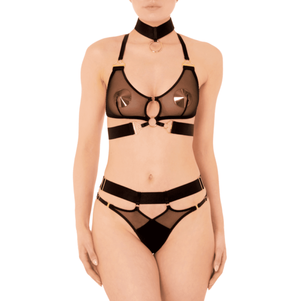 The Kora Noir collection by Bordelle on Brigade Mondaine is directly inspired by the story of Persephone. Also known as Kora, goddess of spring and queen of the underworld. Kora is personified by the constellation Virgo in Greek mythology. Kora revives the DNA of Bordelle, strong contrasts between soft, electric and luxurious materials. Lingerie pieces to be worn day and night, on top and underneath... Bold chameleon designs, strong and powerful lingerie that must be seen by all, like an armor. Kora is a line of lingerie with contemporary and versatile shapes; its pieces are mostly made of removable elements to be worn in a multitude of ways. Kora is handcrafted from satin elastic straps, 24 karat gold plated hardware, wide band elastic and luxuriously soft plain mesh.The Kora Thong can be worn with any look from the Kora line. Combining both soft and sheer mesh, the Kora Thong is a delicate balance of classic and contemporary. 24 karat gold plated finish. Fully adjustable to your body shape. Maximum comfort guaranteed.Kora bondage choker necklace is a coveted Bordelle accessory, featuring hand-woven satin elastic detail, 24-karat gold-plated branded connector and distinct oversized O-ring. One size fits all and fully adjustable. These items are available at Brigade Mondaine