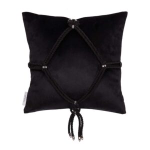 This soft velvet pillow with a Shibari ornament tied on the front - the classic "Kikkou" diamond pattern. Executed in the same manner as all other Figure of A products, with gunmetal hardware and dangling spiked rope ends, it's a unique gift that looks great placed on a sofa or bed. This pillow is available at Brigade Mondaine.