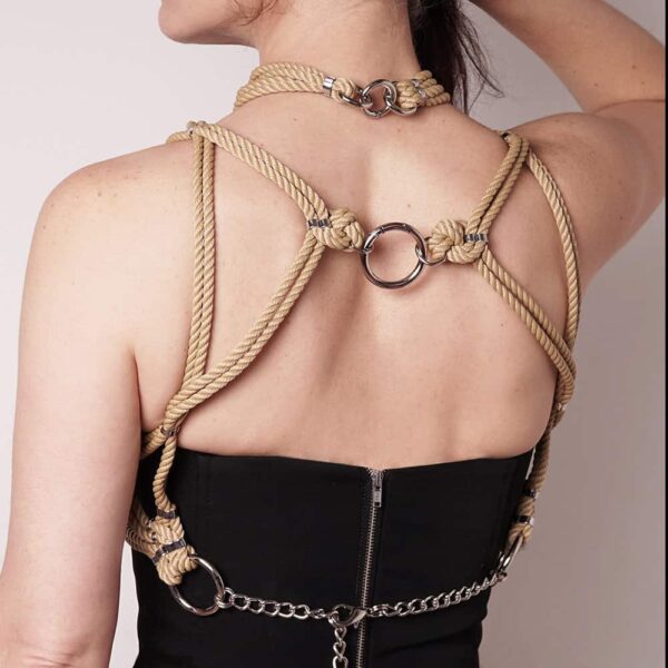 "Mune" means chest or a chest accentuating shape in Japanese. The Mune set consists of a harness and a removable collar. The harness with its bra shape will enhance your cleavage. The choker necklace can be worn attached to the harness or alone. Closing in the back. Silver finish. Fully adjustable. This set is available at Brigade Mondaine.
