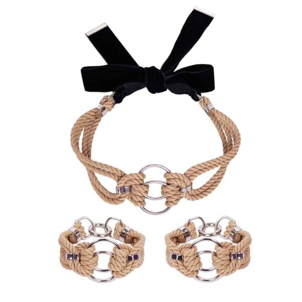 This elegant set includes a choker necklace, a pair of bracelets and a double chain. The metal chain connects the wrists to the necklace with 3 carabiners. The chain can be worn in several ways - with the choker only, being draped around the body or it can be completely detached. Each of the pieces can be worn individually. It is available at Brigade Mondaine.