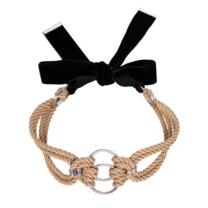 This elegant, snug-fitting choker features two O-rings intertwined with traditional symmetrical polyester rope knots. It is finished with silver zinc alloy and brass hardware. A satin ribbon can be tied in a knot in the back for a custom fit. One size fits all. It is available at Brigade Mondaine.