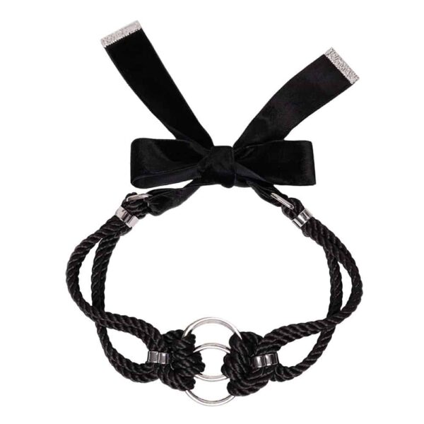 This elegant, snug-fitting choker features two O-rings intertwined with traditional symmetrical polyester rope knots. It is finished with silver zinc alloy and brass hardware. A satin ribbon can be tied in a knot in the back for a custom fit. One size fits all. It is available at Brigade Mondaine.