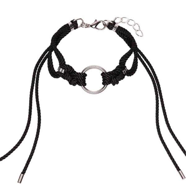 Dieser aufwendige und passgenaue Shippo Noir Choker hat einen großen O-Ring mit traditionellen symmetrischen Knoten aus Polyesterseil, wobei die langen, lockeren Schwänze den Hals einrahmen. Er ist mit einer silbernen Zinklegierung und Messingbeschlägen veredelt. Ein Verschluss und eine Kette auf der Rückseite können für eine individuelle Passform verstellt werden. Die Größe ist eine Einheitsgröße. Erhältlich bei Brigade Mondaine.