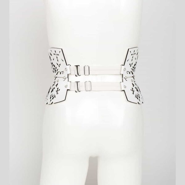 Garters belt from the Original Sin Bianco collection by Fraulein Kink on Brigade Mondaine. Entirely handmade to order in the brand's Berlin workshop from laser-cut white patent leather and ivory pearl rivets, the Bianco Garters Belt will leave no one indifferent at your fetish or erotic parties. This true statement piece is the ultimate in high fashion glamour. Wear with lingerie or over a pencil skirt for a high fashion look. Custom laser-cut white patent leather belt and suspenders. Adjustable leather and satin suspender belt and removable elastic straps. Crystal rivets edged with ivory pearl silver.