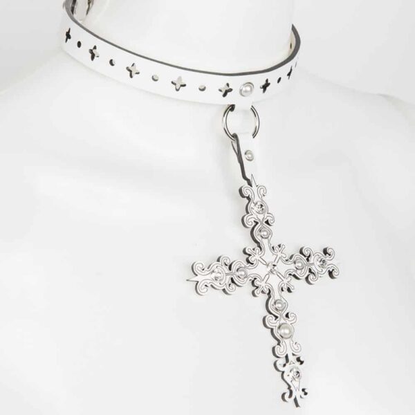 Choker from Fraulein Kink's Original Sin Bianco collection on Brigade Mondaine. Entirely handmade to order in the brand's Berlin workshop from laser-cut glossy white patent leather, silver trim, ivory beads and Swarovski® crystal rivets, the Bianco choker will leave no one indifferent at your fetish or erotic parties. Laser-cut cross and choker in shiny white patent leather. Crystal rivets edged with clear SWAROVSKI® silver. Double cap rivets rimmed with ivory pearl silver. Large silver-plated lobster clasp.