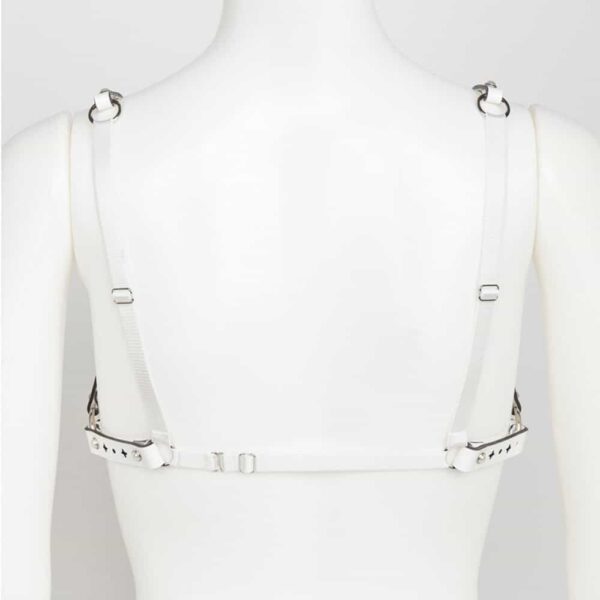 Bianco White Fräulein Kink Open Bra on Brigade Mondaine, made entirely by hand and to order in the brand's Berlin workshops from laser-cut patent leather with high-quality pearl rivets, the Bianco Open Bra is meant to be a trendy lingerie piece or accessory like a bust harness. Wear this glamorous bra over your favorite silk blouse, dress or directly on the skin. A perfect accessory for inside or outside the bedroom.Double cap rivets ringed in ivory pearl silver. Adjustable double-sided white satin elastic straps. Adjustable stretch back hook closure.