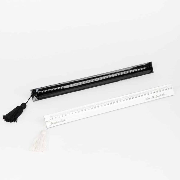 White paddle ruler from the Original Sin Bianco collection by Fraulein Kink by Brigade Mondaine. Entirely handmade to order in the brand's Berlin workshop from laser-cut patent leather on a wooden base, this bondage piece is embellished with a pom-pom for caressing and teasing. The Paddle Ruler Bianco is the ultimate luxury accessory for spanking. Spank and tease your lover!