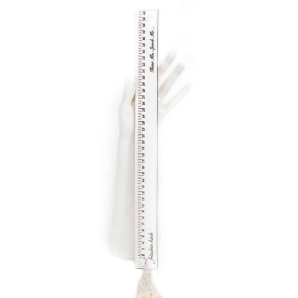 White paddle ruler from the Original Sin Bianco collection by Fraulein Kink by Brigade Mondaine. Entirely handmade to order in the brand's Berlin workshop from laser-cut patent leather on a wooden base, this bondage piece is embellished with a pom-pom for caressing and teasing. The Paddle Ruler Bianco is the ultimate luxury accessory for spanking. Spank and tease your lover!