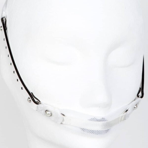 Gag Bianco White Fräulein Kink on Brigade Mondaine, entirely handmade and made to order, in the workshops of the brand in Berlin, the GAG gag Bianco will not leave anyone indifferent during your fetish or erotic evenings. Ultra comfortable and versatile, this gag is sure to bring out the naughty in you. Wear it as a hair accessory, a high waist belt or a necklace. Elegant gag in ivory stretch tulle. Ivory pearl silver edged crystals. Custom laser-cut white leather straps. Double sided satin ribbon closure. Ultra comfortable and easy to wash.