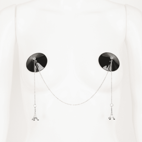 Eiffel double chain nippies from the French Kiss collection by Fraulein Kink on Brigade Mondaine. Nippies in shiny black leather with silver plated chains with silver mini Eiffel towers, Swarovski crystal rivets. The entire French Kiss collection is handmade to order in the designer's Berlin atelier. This collection is inspired by French luxury with accessories that represent the capital of fashion, Paris. Fraulein kink offers couture pieces that you won't see anywhere else.