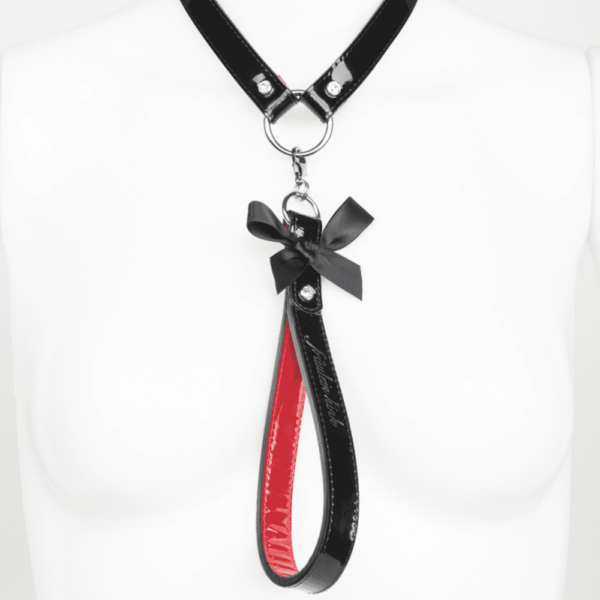 Black and red patent leather leash, with a nine on the front, from the French Kiss collection by Fraulein Kink, available at Brigade Mondaine