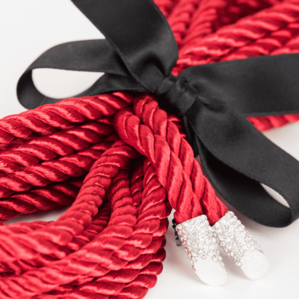 Red shibari rope from the French Kiss collection by Fraulein Kink on Brigade Mondaine. 5 meters of red shibari rope with crystal tip, tie your lover or wear it as a belt or harness to add a special high fashion touch to your favorite outfit. The entire French Kiss collection is handmade to order in the designer's studio in Berlin. This collection is inspired by French luxury with accessories that represent the fashion capital, Paris. Fraulein kink offers couture pieces that you won't see anywhere else.