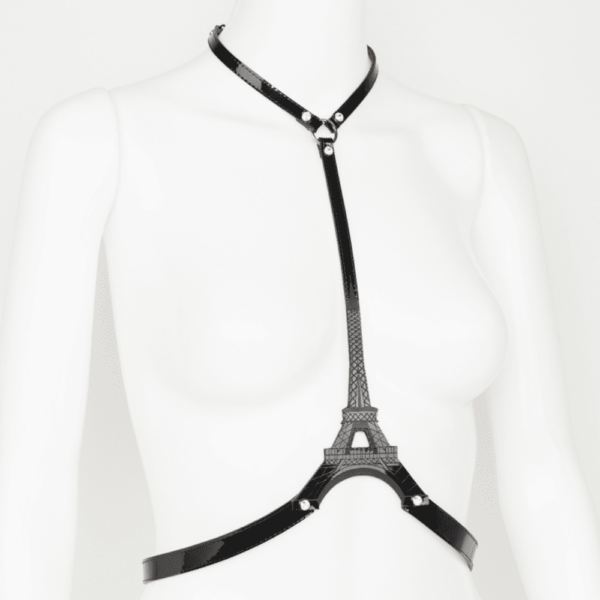 Eiffel Harness from the French Kiss collection by Fraulein Kink on Brigade Mondaine, a real showpiece! Featuring a laser-embossed Eiffel Tower, the emblematic symbol of Parisian style. This chic harness can be worn over your favorite dress, jumpsuit, blouse or directly on the skin. Sewn-on straps in glossy black and red patent leather. Laser-engraved Eiffel Tower design. Crystal rivets edged with clear SWAROVSKI silver. Adjustable double-sided satin elastic straps. Adjustable rear stretch hook closure. The entire French Kiss collection is handmade to order in the designer's Berlin atelier. The collection is inspired by French luxury, with accessories that represent the fashion capital, Paris. Fraulein kink offers couture pieces you won't see anywhere else.