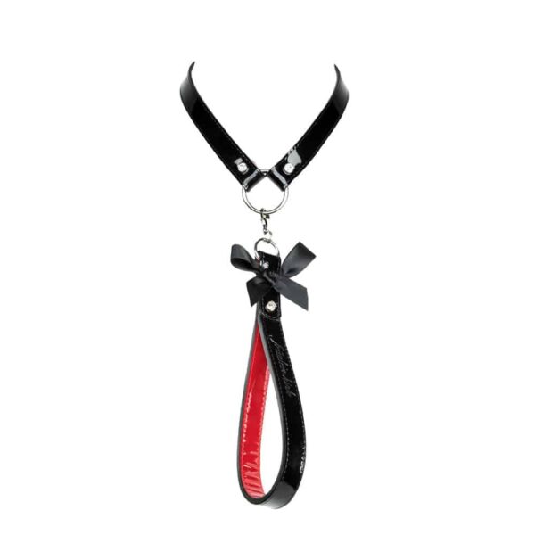 Black and red patent leather leash, with a nine on the front, from the French Kiss collection by Fraulein Kink, available at Brigade Mondaine