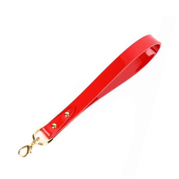 Excite and tease with the ultimate bedroom accessory! Our Roja Flogger is handcrafted from a combination of Italian patent leather and matte red. The flogger features a detachable handle and 24K gold rivet and chain details to add the perfect finishing touch to this high fashion accessory. Red Italian patent and matte leather straps Wood reinforced shaft Removable 24K Gold Rivet & Chain Accent handle