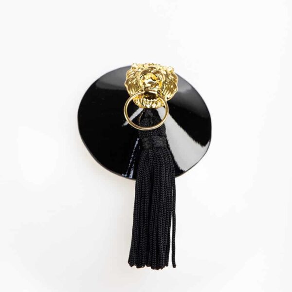 The ultimate object of desire, molded in high quality Italian patent leather and embellished with gold brass rivets, these Leone nipple covers are adorned with gold lion head and pompom details. Wear with an open bra or just under a transparent top for a very haute-couture look.