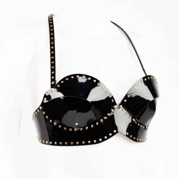 The Ricco strapless bra is one of the highlights of the Riche collection. This luxurious piece is made to be seen! Very chic, the Ricco bra in black Italian patent leather has removable straps, gold brass double cap rivets, it can be worn both over your favorite silk blouse or dress, or directly on the skin. Black adjustable and removable bra straps. Stretchy and adjustable back hook closure. Available in 3 sizes.